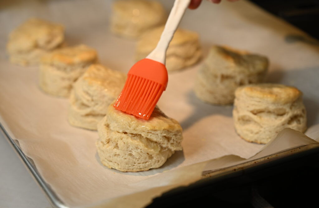 Melted butter brushed over top of warm biscuits