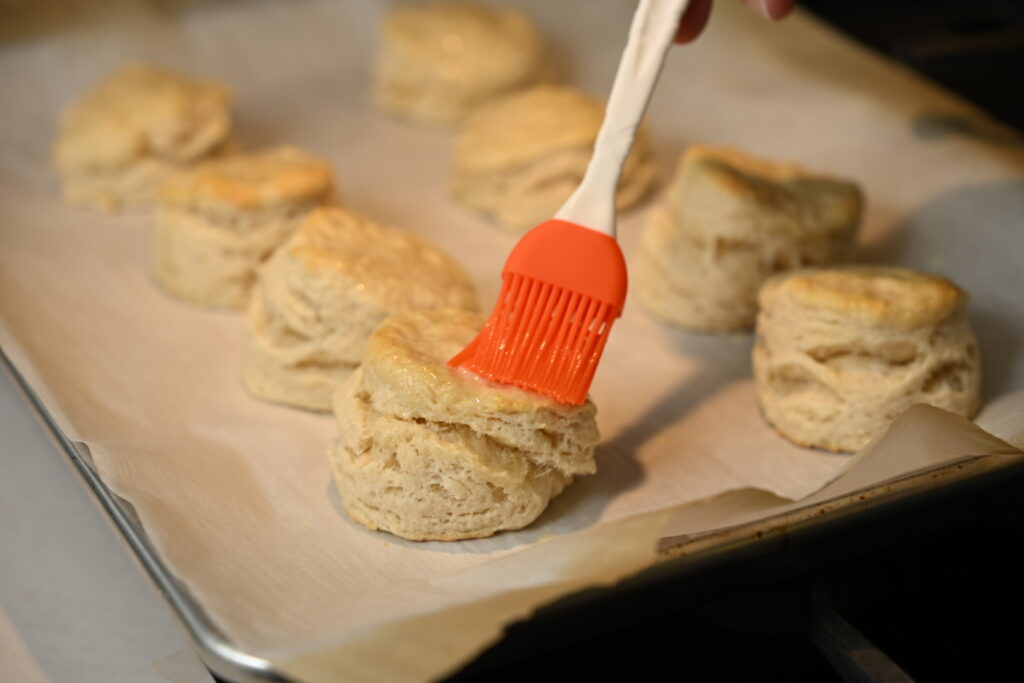 Homemade biscuits topped with melted butter