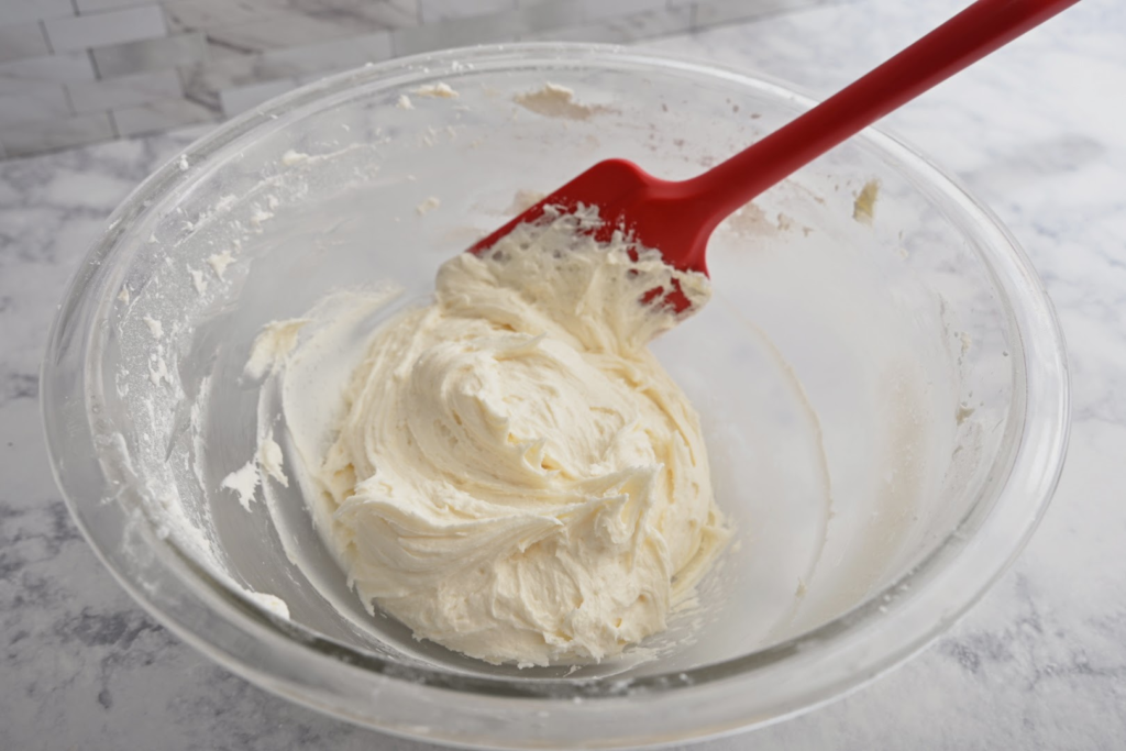whipped marshmallow buttercream, top layer of frosted s'mores cookies