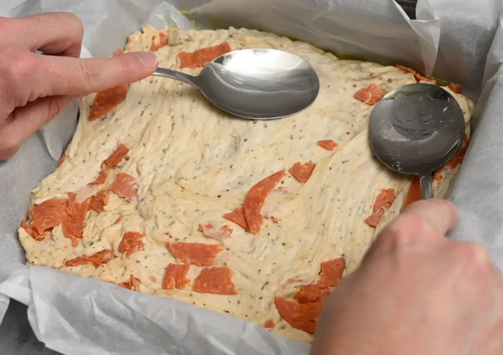 spread dough out to corners of prepared pan