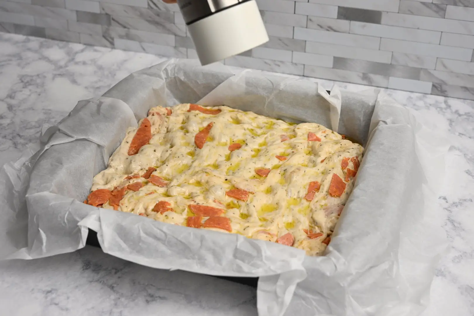 grind salt on top of Pepperoni Focaccia Bread