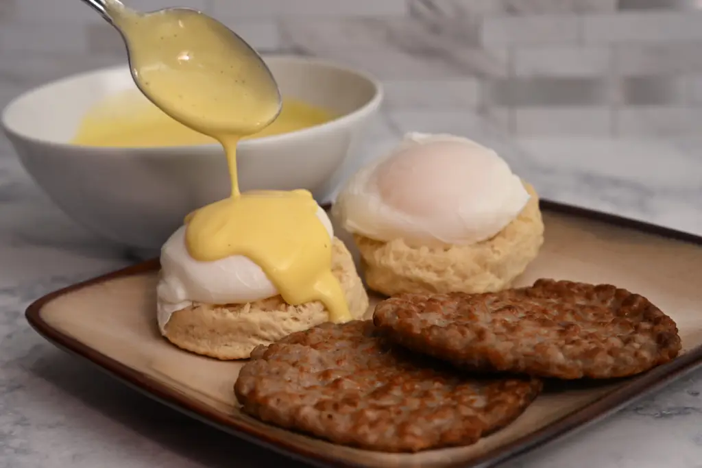 Poached eggs topped with creamy hollandaise sauce
